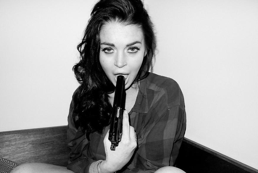 Lindsay Lohan posa com arma em ensaio polêmico